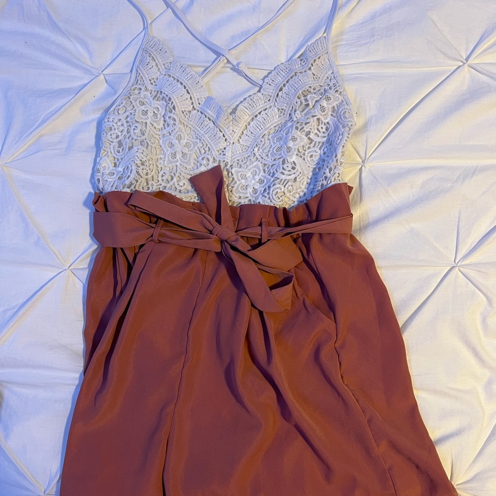 I am selling a pink and white romper size M, with an opened back
